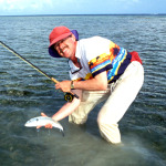 picture of a flyfisher with a bonefish caught with flyfishing gear in Mexico's Yucatan.